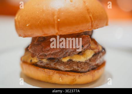 Juicy beef burger with melted cheese in close-up view Stock Photo