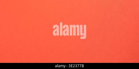 Vivid orange red paper, background with refined warmth. Smooth satin surface shows subtle metallic shimmer and fine grain under soft light. Clean mode Stock Photo