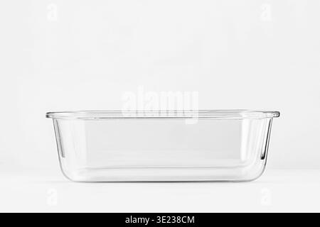 Empty glass food container on light background, transparent baking dish side view, minimalist kitchen cookware, glass storStudio shot of an empty tran Stock Photo