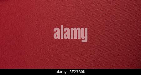 deep red textured background with flat surface. Fine woven grain and matte tactile material create a calm minimal abstract backdrop for branding and p Stock Photo