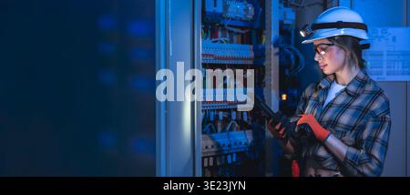 Electrical engineer inspecting power system using tablet. Technical maintenance. Stock Photo