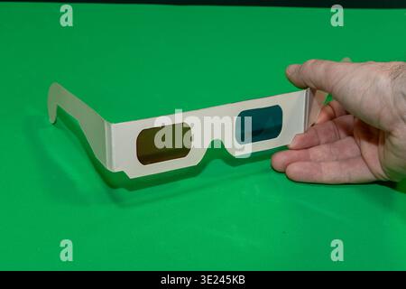 A Hand Holding 3d Glasses for Cinema with a Chroma Background Stock Photo