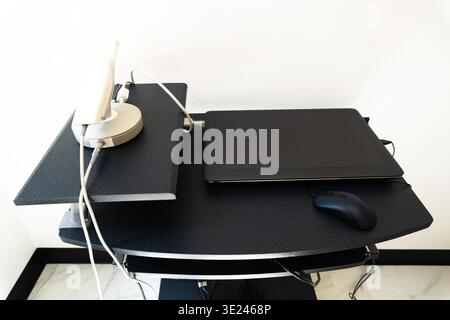 Modern minimalist desk setup featuring orderly laptop and accessories in a bright office Stock Photo
