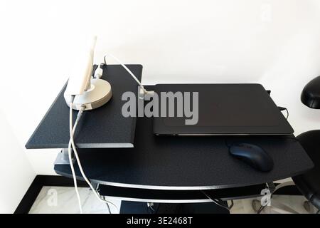 Modern minimalist desk setup featuring orderly laptop and accessories in a bright office Stock Photo