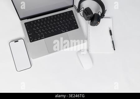 Minimal Home Office Desk Flat Lay with Laptop Headphones and Smartphone Stock Photo