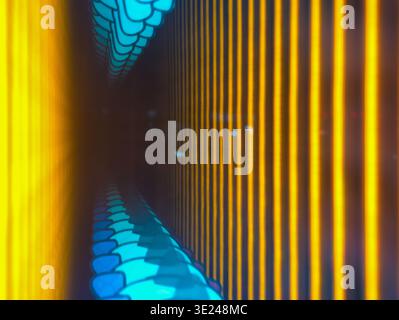 Macro or abstract digital art style image featuring bright vertical yellow light lines contrasting with glowing blue hexagonal or honeycomb patterns i Stock Photo
