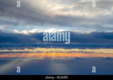 Sun rays streaming through dramatic clouds.  Beautiful images of sun, clouds and skies. Colorful and vibrant natural beauty in the sky. Stock Photo