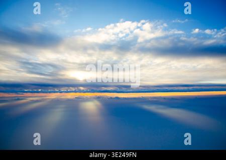 Sun rays streaming through dramatic clouds.  Beautiful images of sun, clouds and skies. Colorful and vibrant natural beauty in the sky. Stock Photo