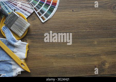 Various painting tools, accessories and color samples for home renovation on wooden background Stock Photo