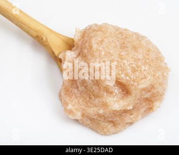 Salty caviar of zander fish in wooden spoon on white plate close up Stock Photo
