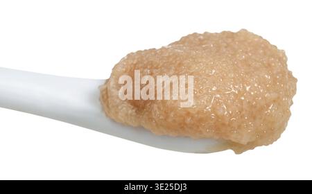 Salty caviar of cod fish in ceramic spoon isolated on white background Stock Photo