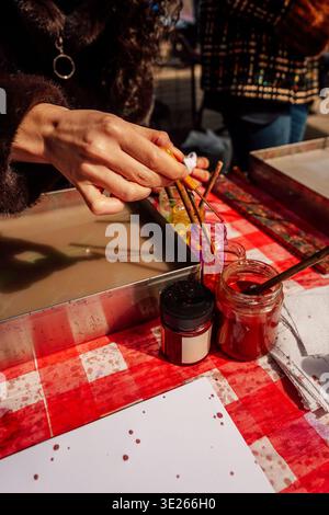 Creative Workshop Outdoors Where Colors Swirl And Merge On Water With Tools And Jars Stock Photo
