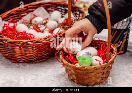Festive Egg Decoration. Handcrafting Painted Eggs Surrounded By Vibrant Shredded Paper And Markers Stock Photo