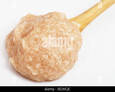 Salty caviar of zander fish in wooden spoon on white plate close up Stock Photo
