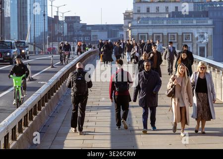 London bridge commuters walking and cycling during morning rush hour Stock Photo
