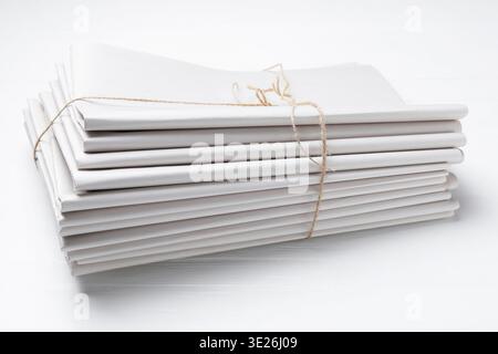 Stack of folded newspapers on white wooden table, closeup Stock Photo