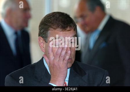 A bleary eyed Prince Andrew, one eye shut, during a visit to Kingston Communications (now KCOM), Hull, UK,  on the 6 July 2004. He is pictured rubbing Stock Photo