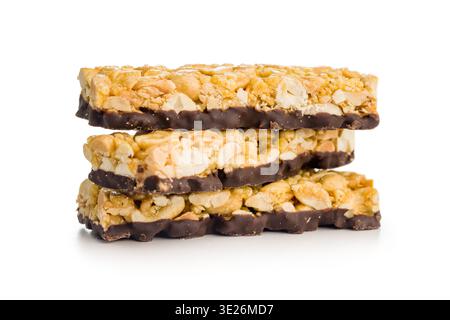 Stacked chocolate-coated peanut granola bars with visible peanuts and caramel, isolated on a white background. Crunchy, sweet snack perfect for breakf Stock Photo