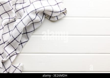 Bright white wooden background with a striped linen towel draped at the edge, offering clean minimal texture and plenty of copy space for food photogr Stock Photo