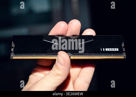 Fast DDR5 memory module held in hand. Stock Photo