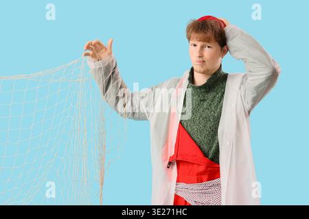 Funny young man with fishnet on blue background Stock Photo