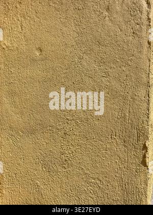 Sunfilled Stucco Exterior Featuring Warm Yellow Tones And Delicate Shadow Play For Branding Purposes Stock Photo