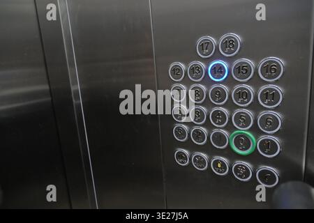 Button panel shows elevator options on a steel surface Stock Photo