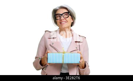 Smiling senior woman holding a gift box Stock Photo