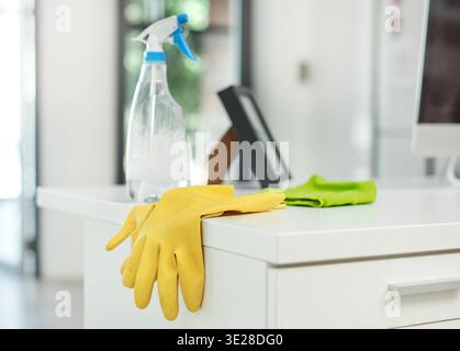 Gloves, detergent and cleaning supplies on desk in office for company hygiene, dust removal and safety. Housekeeping, cleaner equipment and products Stock Photo