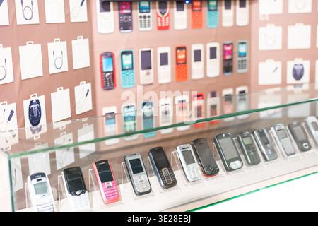 Vintage Mobile Phones Displayed in Glass Case at Electronics Store in Shanghai, China Stock Photo