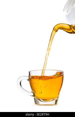 Glass cup of tea with teapot filling, isolated on white background. Stock Photo