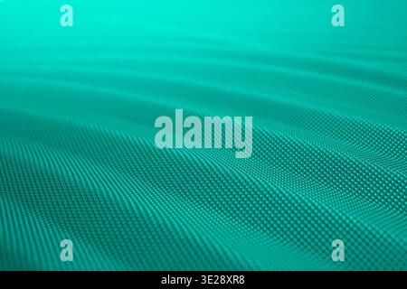 Waved turquoise carbon fiber plastic texture, surface detail close up , abstract patterned  wallpaper Stock Photo