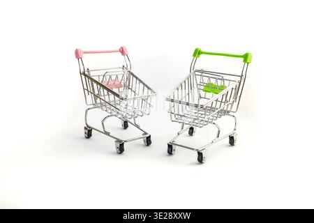 Two pink and green shopping carts issolated on white background Stock Photo