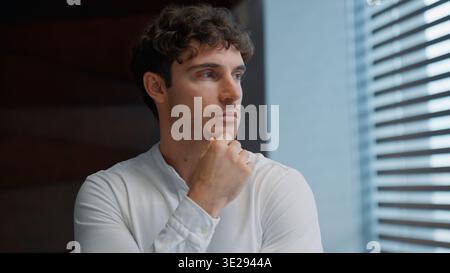 Portrait thinking Caucasian business man looking in window think contemplate puzzled hesitate businessman male guy dream executive specialist Stock Photo