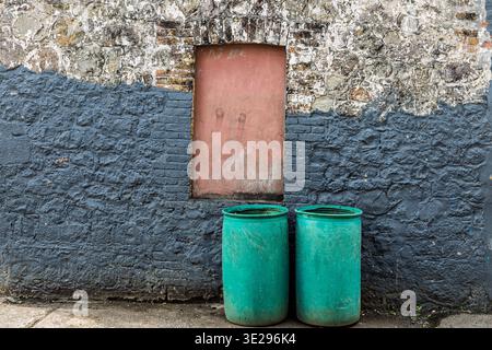 Bins, boarded up window and wall, Victoria, St Mark Parish, Grenada Stock Photo