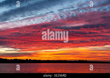 Colourful cloudscape of altocumulus clouds at sunset, IJsselmeer, Netherlands Stock Photo