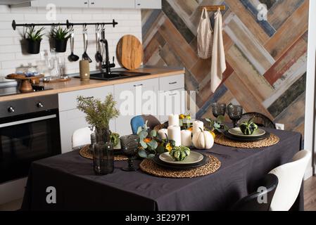 Autumn and halloween table setting. kitchen interior design in rustic style with table ready for dinner Stock Photo