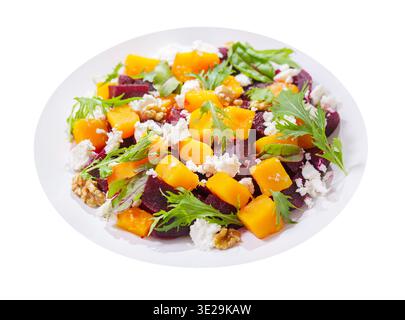 plate of salad with baked pumpkin, beetroot, greens and cream cheese isolated on white background Stock Photo