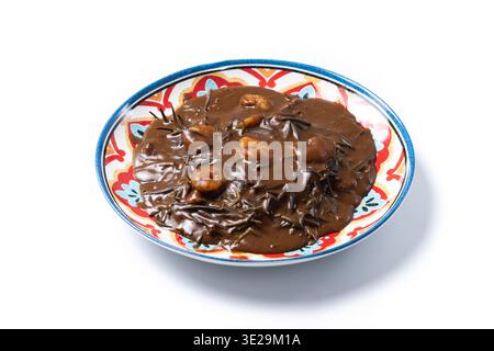 Mexican romeritos with mole sauce and shrimp isolated on white background Stock Photo