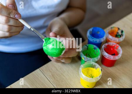 Woman is painting eggs preparing for Easter.  Stock Photo