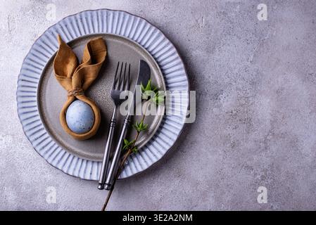 Elegant Easter table setting with painted egg Stock Photo
