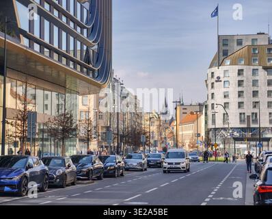 Prague, Czech Republic - March 19, 2026: View along a central Prague boulevard with modern glass architecture, road traffic and Gothic church spires. Stock Photo