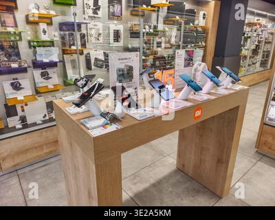 Prague, Czech Republic - March 19, 2026: Xiaomi smartphones displayed on stands inside electronics retail store with promotional signage and pricing Stock Photo