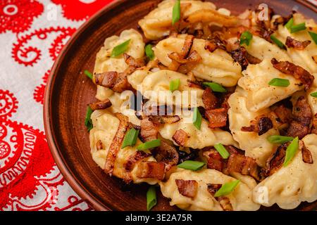 Dumplings, filled with mashed potatoes. Russian, Ukrainian or Polish dish: varenyky, vareniki, pierogi, pyrohy. Stock Photo