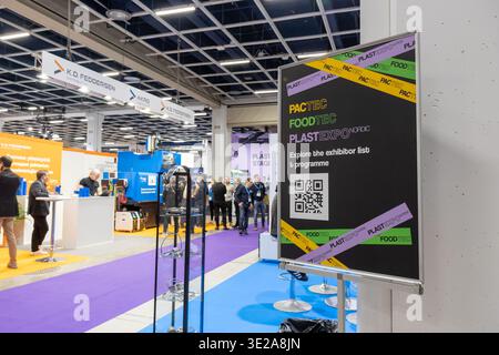 Helsinki, Finland - March 11, 2026: An informational sign with a QR code for PacTec, FoodTec, and PlastExpo Nordic at a busy trade fair exhibition in Stock Photo