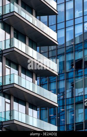 Milan, Lombardy, Italy - Friday 13, 2026: Contemporary building showcasing residential balconies and reflective office windows in an urban environment Stock Photo