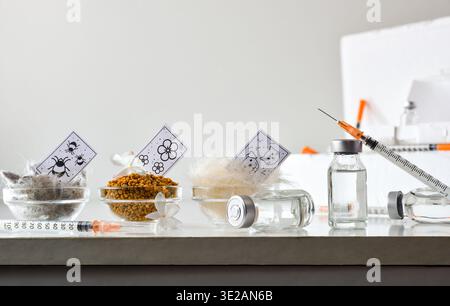 Vaccination concept for various allergens, with a dose, syringe, and allergen jars with an informational poster on a white table and white isolated ba Stock Photo