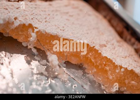 Macro honeycomb on reflective metal tray in Zermatt, Switzerland Stock Photo