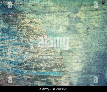 Close up view of a distressed wooden surface with peeling blue and green paint revealing rustic aged texture Stock Photo