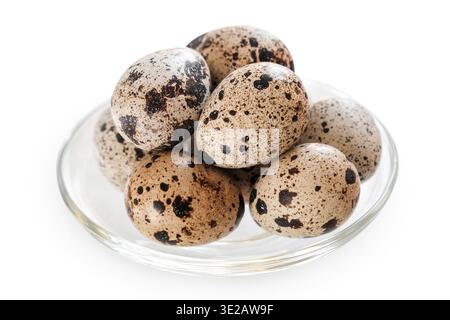 Quail eggs in glass bowl isolated on white background. Easter holiday concept, spring celebration Stock Photo